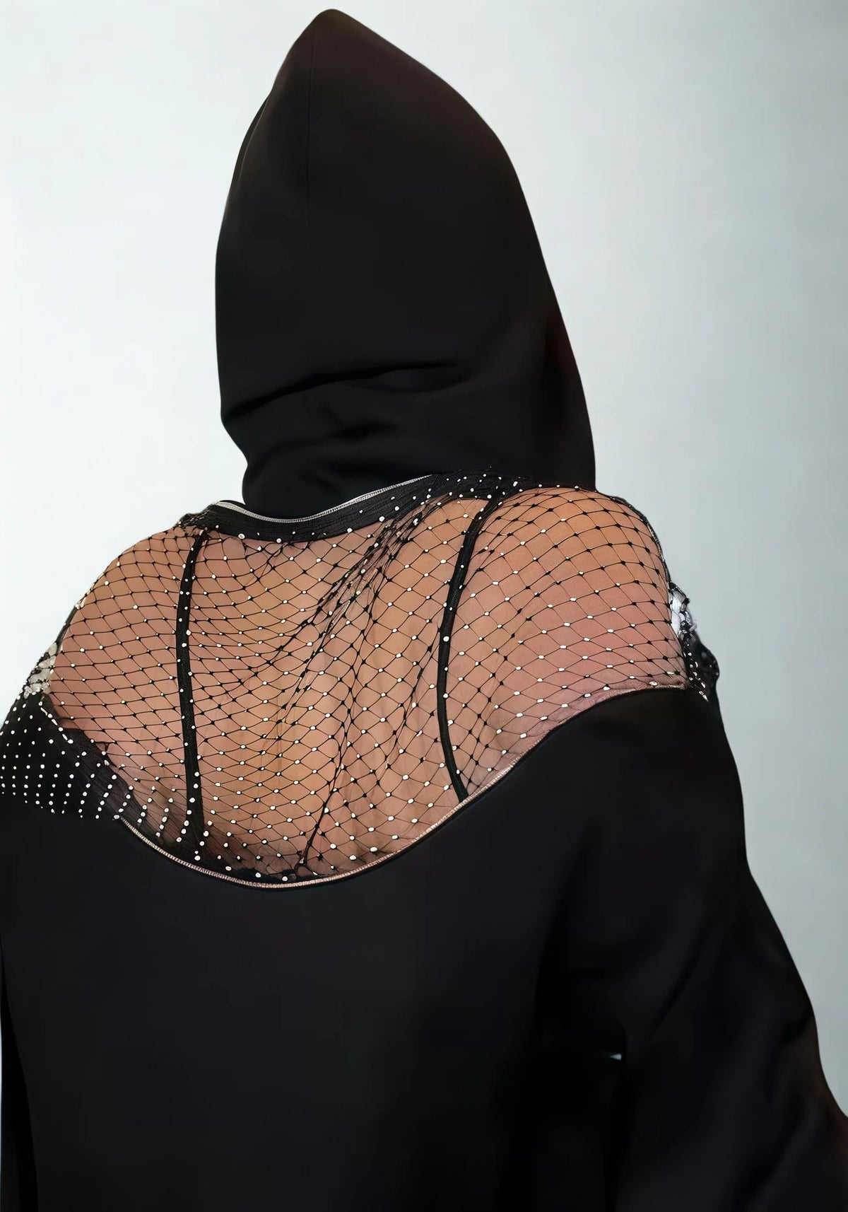 Back view of the black hoodie with zipper and rhinestone-studded mesh